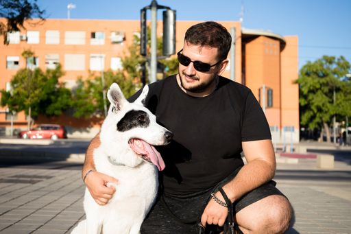 A Caucasian male hugging his dog