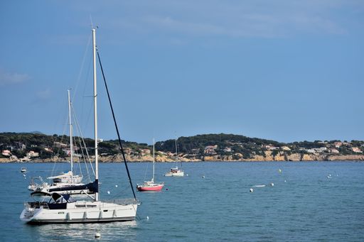 A ship in the sea and hills on a sunny day