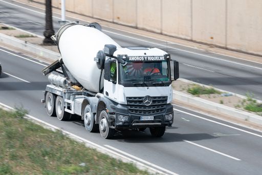 A White Mercedes Arocs concrete mixer on road