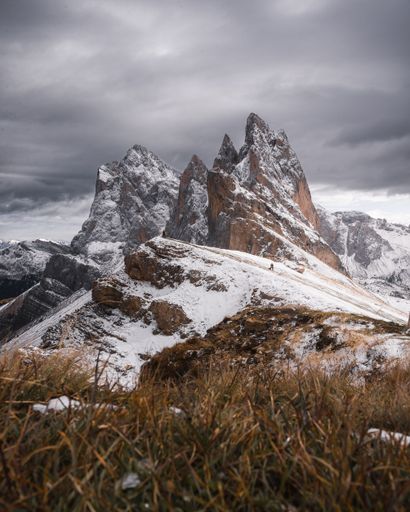 A vertical shot of the jagged peak of Seceda mountain in the Dolomite Alps on a cloudy winter day