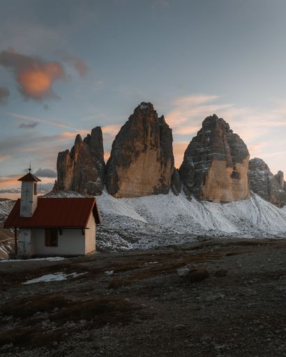An aerial view of church in background of mountains during sunset