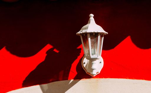A closeup shot of a vintage street lamp on a wall