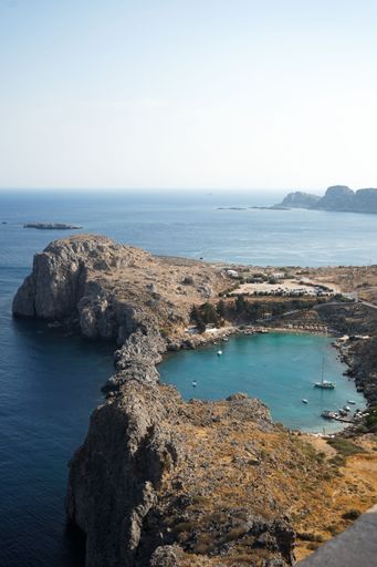 A vertical aerial shot of St Paul's Bay in Lindos Acropolis, Greece.