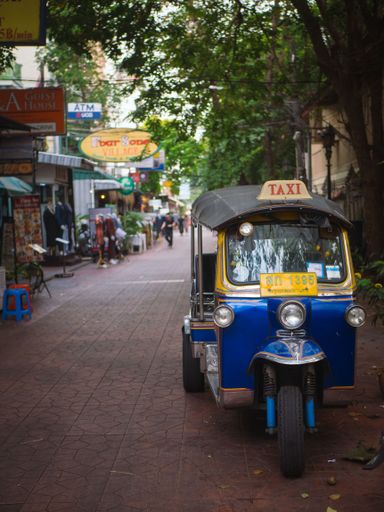 A vertical shot of a Tuk-Tuk taxi on the street in Bangkok, Thailand
