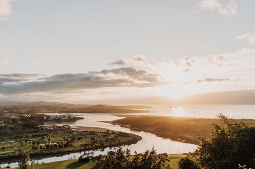 A beautiful shot of a river flowing through nature and the sun shining