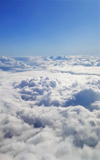 A beautiful scenery of the earth and white clouds seen from a plane