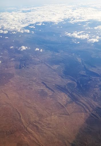 A beautiful scenery of the earth and white clouds seen from a plane
