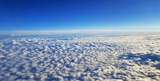 A beautiful scenery of the earth and white clouds seen from a plane