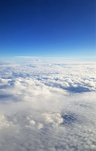 A beautiful scenery of the earth and white clouds seen from a plane