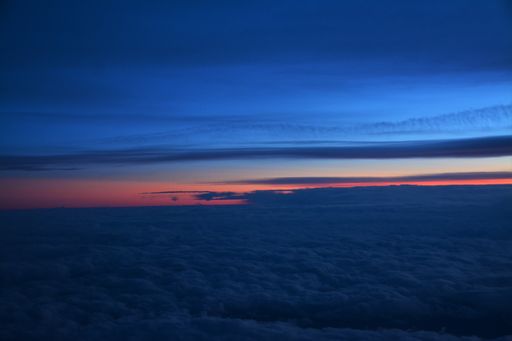A breathtaking view of beautiful white clouds seen from above at sunset