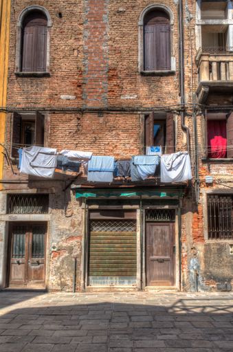 A vertical shot of drying clothes on clothesline in Italy