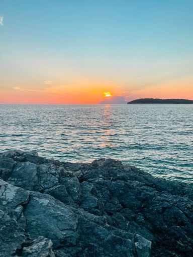 - A beautiful sunset in the beautiful country called croatia. A dramatic but beautiful sky. With a nice foreground with rocks and still small mountain
