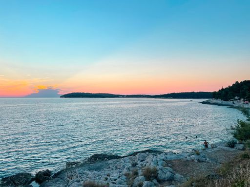 A beautiful sunset in the beautiful country called croatia. A dramatic but beautiful sky. With a nice foreground with rocks and still small mountains