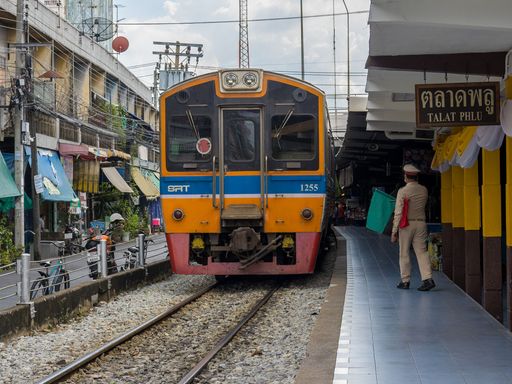 The view of the urban train on the rails by the station in Thailand