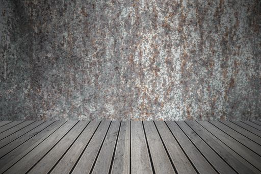 A closeup of a wooden table against a weathered wall - perfect for wallpapers