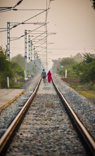 A couple walking on the railway
