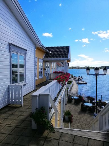 A vertical shot of the houses near the sea from the village of Gjeving, Norway