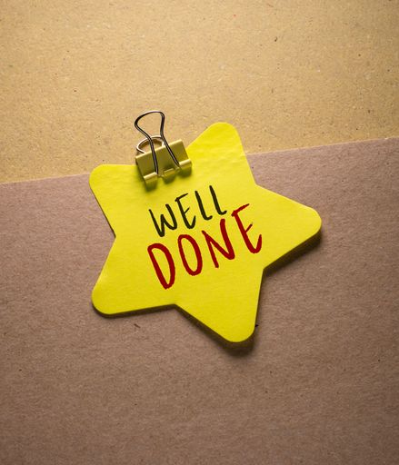Close up conceptual shot of a business idea showing Well Done