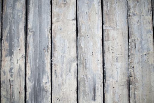 A closeup shot of a wall made of vertical wooden planks - perfect for a cool wallpaper background