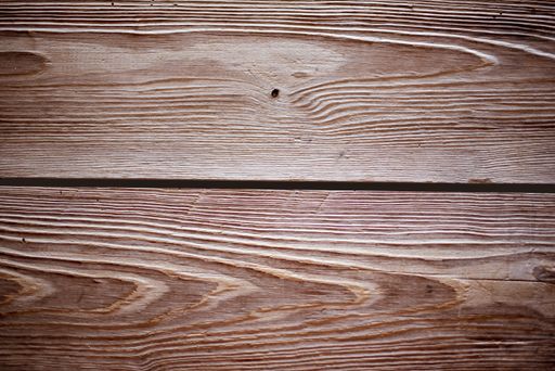 A closeup shot of a wall made of horizontal brown wooden planks - perfect for a cool wallpaper background
