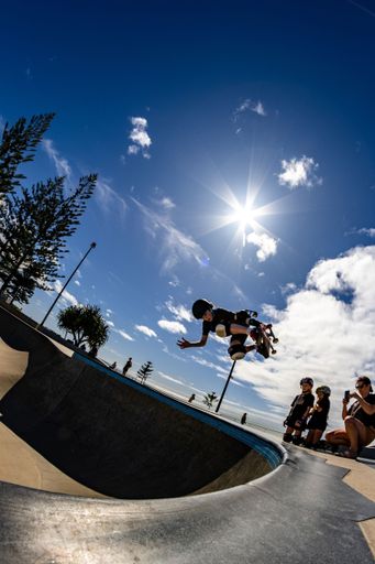A beautiful shot of a young skateboarder doing some tricks at Alex Skate Park in Australia