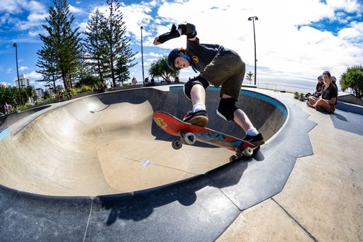 A beautiful shot of a young skateboarder doing some tricks at Alex Skate Park in Australia