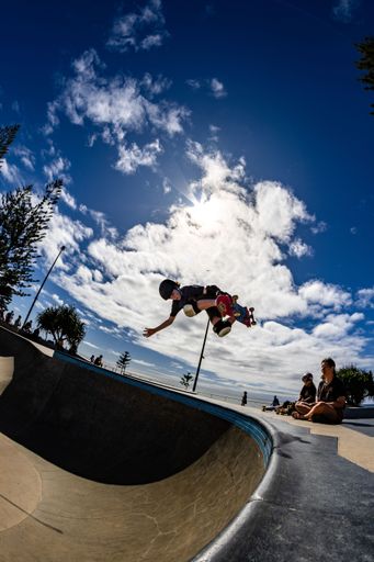 A beautiful shot of a young skateboarder doing some tricks at Alex Skate Park in Australia