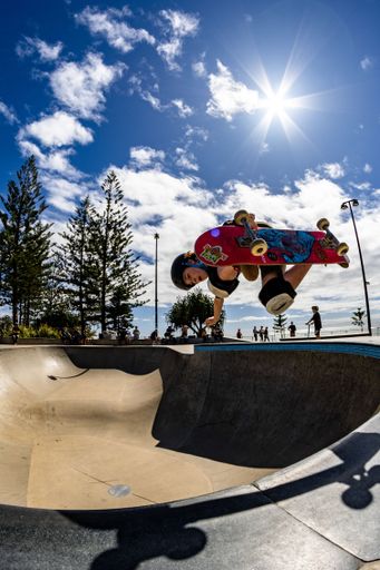 A beautiful shot of a young skateboarder doing some tricks at Alex Skate Park in Australia