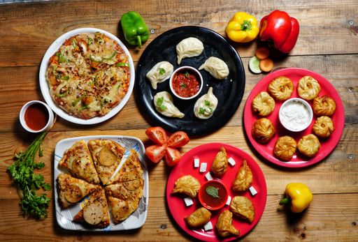 A top view of momos and pizza