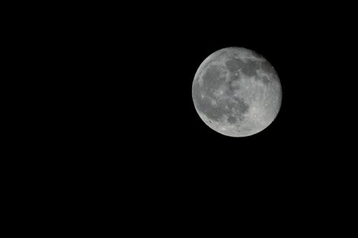 The full moon in a dark night sky