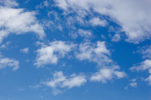 A low angle shot of clouds in the blue sky