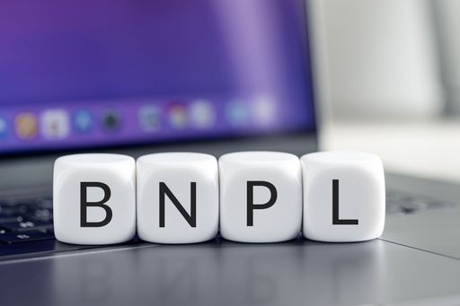 BNPL or Buy now pay later concept. Text on cube blocks on laptop