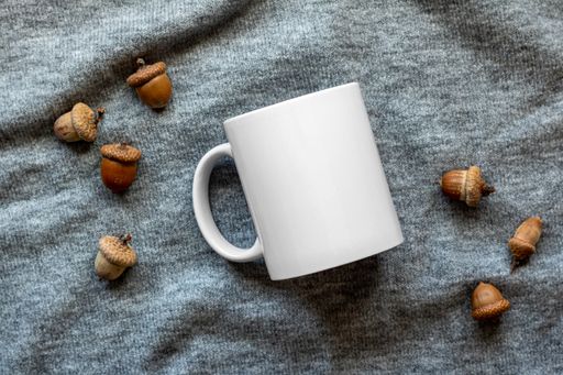 A closeup shot of a mug and acorns