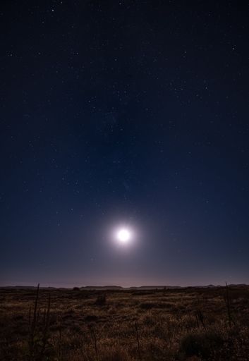 A beautiful view of a moon over field