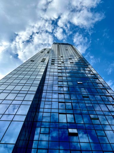 A vertical low-angle shot of the West 65 skyscraper in Belgrade, Serbia.