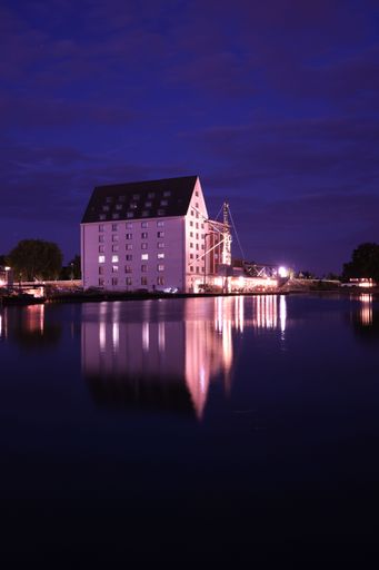 A vertical shot of s house illuminated at sunset in the harbor of Munster, Germany