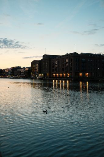 A vertical shot of an old brick building illuminated at sunset in the harbor of Munster, Germany