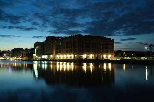 An old brick building illuminated at sunset in the harbor of Munster, Germany
