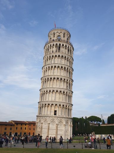 The leaning tower of Pisa and Piazza dei Miracoli in a sunny day - The Miracle Square, the Leaning Tower and the Cathedral in Pisa, Tuscany, Italy