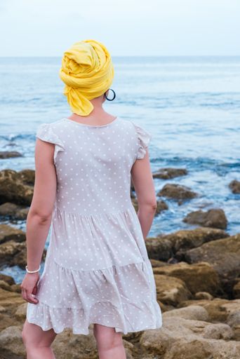 A selective focus shot of young female relaxing at the seaside