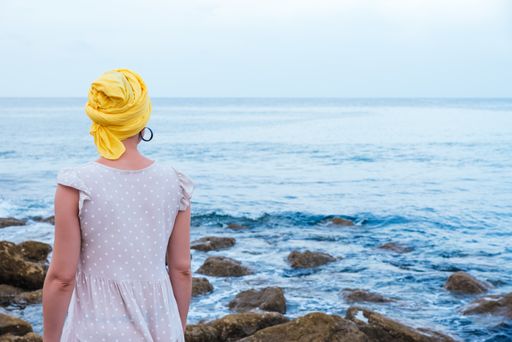 A selective focus shot of young female relaxing at the seaside