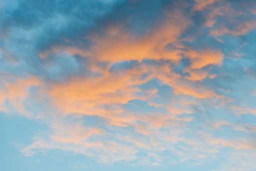 A beautiful shot of the sky filled with clouds during an orange sunset