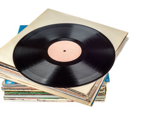 An isolated shot of a stack of vinyl music records on a white background