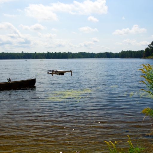 A selective focus shot of a drone camera flying over a lake