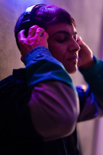 A portrait of a Caucasian (White) male listening to music with headphones
