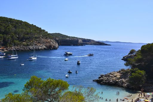 A high angle shot of boats in the sea and the seaside
