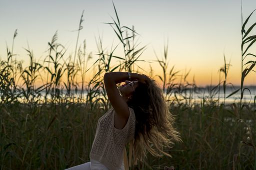 A shallow focus shot of a Caucasian female posing outdoors
