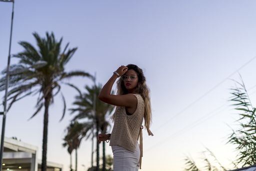 A shallow focus shot of a Caucasian female posing outdoors