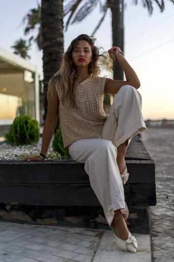 A vertical shallow focus shot of a Caucasian female posing outdoors