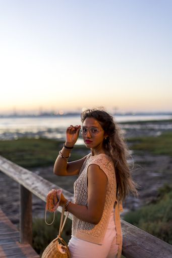 A shallow focus shot of a young mulatto female on a seaside background